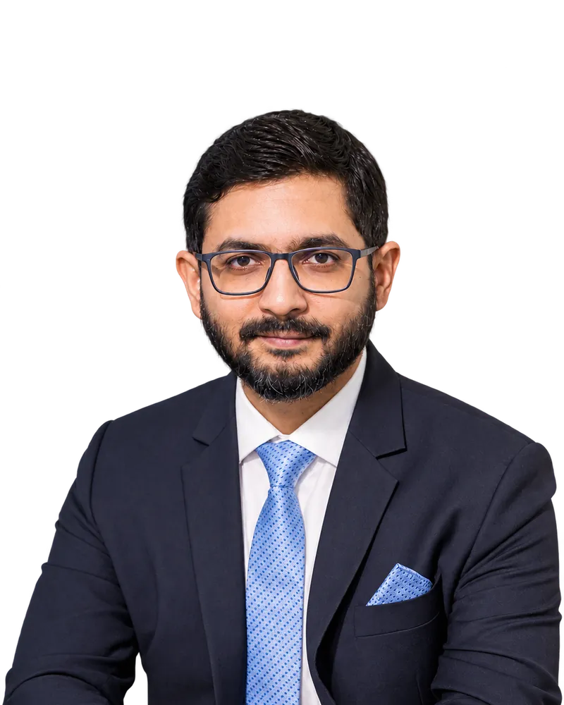 Portrait of Saidur Khan in a navy suit and light blue tie